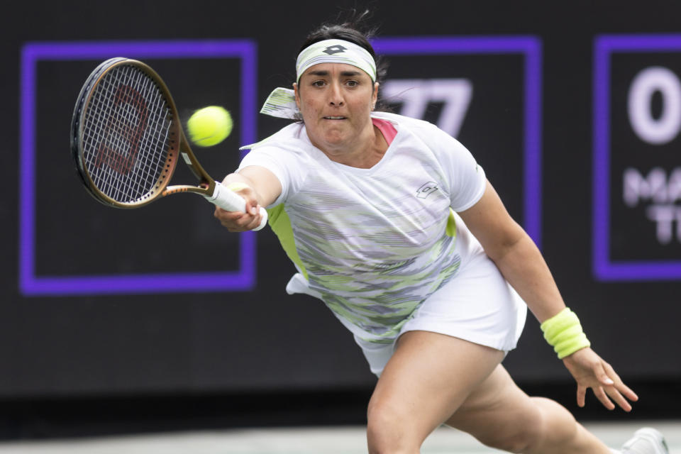 FILE - Ons Jabeur, of Tunisia, returns a shot to Belinda Bencic, of Switzerland, during the championship match at the Charleston Open tennis tournament in Charleston, S.C., Sunday, April 9, 2023. Jabeur is expected to compete at Wimbledon next week. (AP Photo/Mic Smith, File)