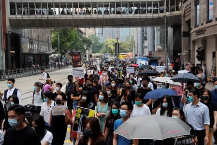 People protest against what they say is the abuse of pro-democracy protesters by Hong Kong police, at Chater Garden in Central district