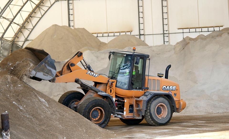 Tim Pryor mixes grit and salt in the Ashland County Highway Department's salt bin on Cleveland Avenue on Tuesday, Feb. 1, 2022. Pryor said he was preparing a 50/50 mix of grit and sand that works well on ice for the upcoming storm. TOM E. PUSKAR/TIMES-GAZETTE.COM