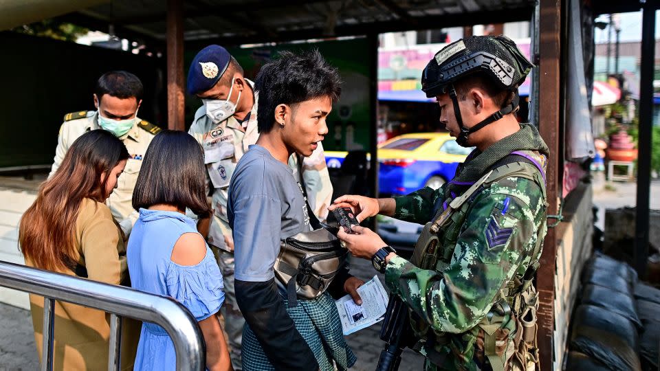Thai military personnel check a Myanmar national's bag after he crossed into Thailand at the Tak border checkpoint in Mae Sot on April 11, 2024. - Manan Vatsyayana/AFP/Getty Images