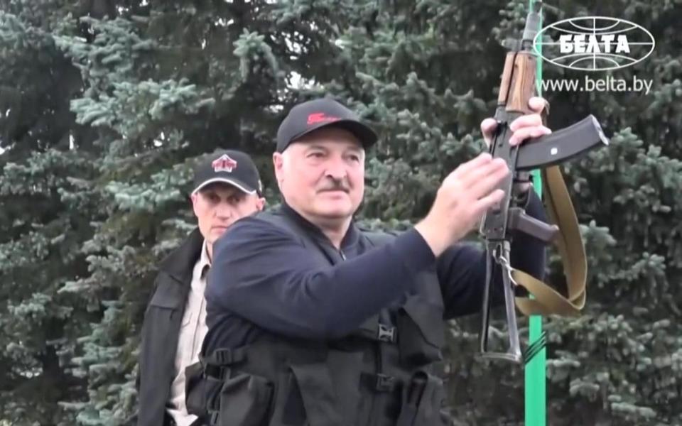 State video showed President Lukashenko holding an automatic rifle -  AFP