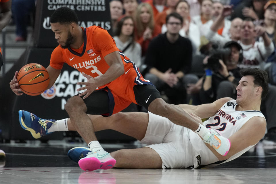 Illinois' Jayden Epps (3) and Virginia's Francisco Caffaro (22) scramble for the ball during the first half of an NCAA college basketball game Sunday, Nov. 20, 2022, in Las Vegas. (AP Photo/John Locher)