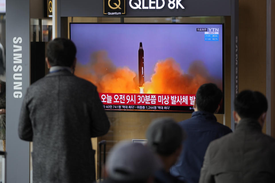 People watch a TV screen showing a news program reporting about North Korea's missile with file footage, at a train station in Seoul, South Korea, Wednesday, March 16, 2022. North Korea's latest weapons launch on Wednesday apparently ended in failure, South Korea' military said, amid speculation that the North could soon launch its biggest long-range missile in its most significant provocation in years. (AP Photo/Lee Jin-man)