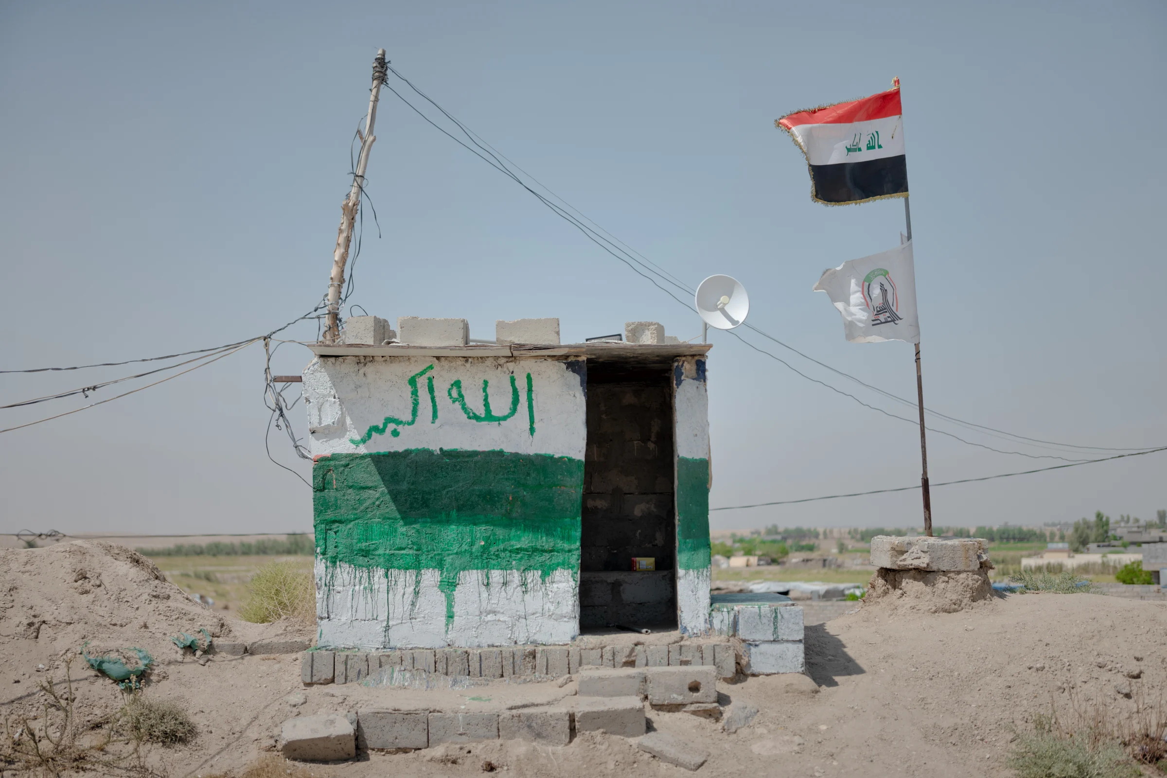 A checkpoint just outside Jurf al-Nasr, a stretch of land south of Baghdad under the total control of an Iran-backed militia called Khataib Hezbollah, on Sept. 23, 2023. (Emily Garthwaite/The New York Times)