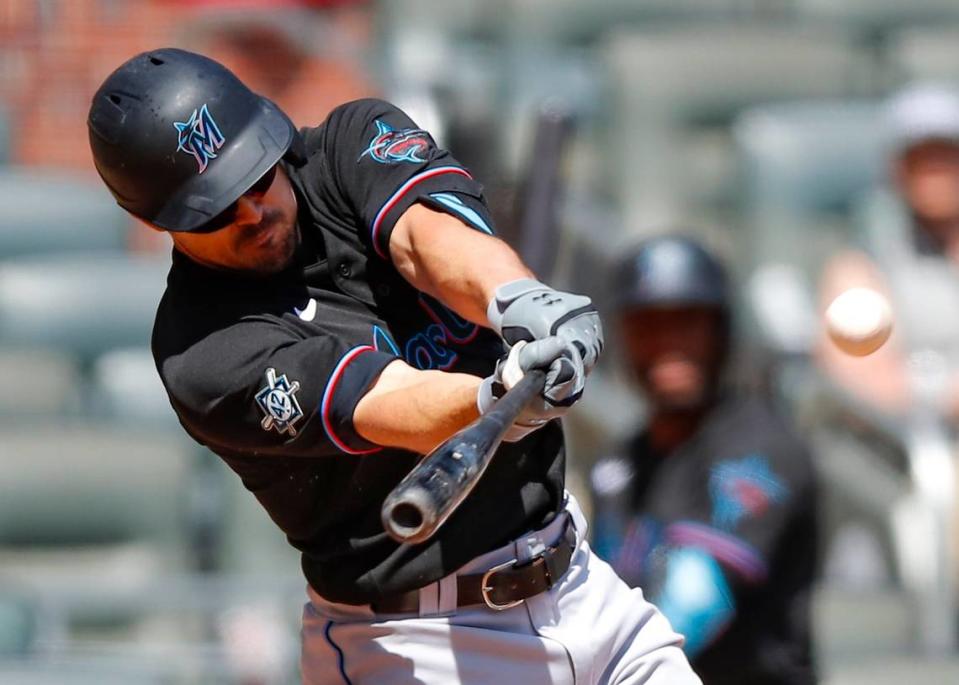 ATLANTA, GA - APRIL 15: Adam Duvall #14 of the Miami Marlins hits an RBI double in the ninth inning of an MLB game against the Atlanta Braves at Truist Park on April 15, 2021 in Atlanta, Georgia. All players are wearing the number 42 in honor of Jackie Robinson Day. (Photo by Todd Kirkland/Getty Images)