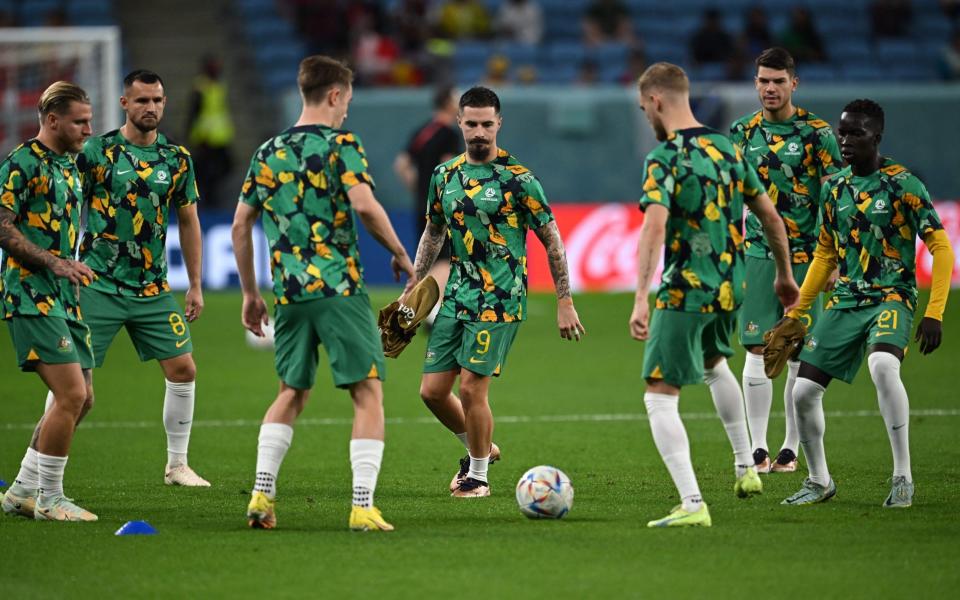 Australia's forward #09 Jamie Maclaren (C) warms up with teammates ahead of the start of the Qatar 2022 World Cup Group D football match between Australia and Denmark at the Al-Janoub Stadium in Al-Wakrah, south of Doha on November 30, 2022. - Paul Ellis/Getty Images