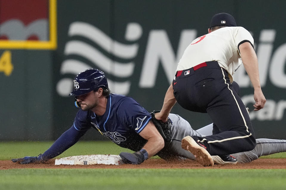 Tampa Bay Rays' Josh Lowe, left, safely steals second base against Texas Rangers shortstop Corey Seager, right, during the sixth inning of a baseball game in Arlington, Texas, Friday, July 5, 2024. (AP Photo/LM Otero)