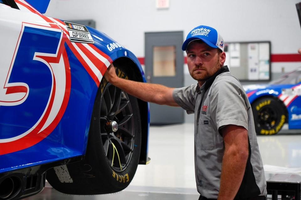 Hendrick Motorsports crew member Marlin Yoder works on one of Cup Series champion Kyle Larson's cars in the team's shop in Concord, North Carolina.