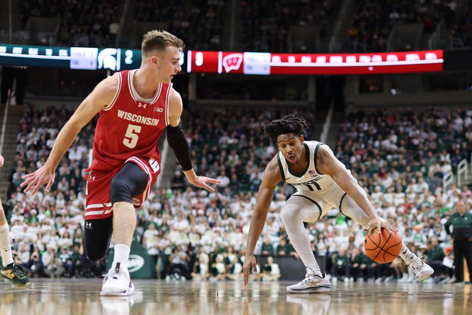 A.J. Hoggard of the Michigan State Spartans drives to the basket and draws a foul from Tyler Wahl of the Wisconsin Badgers during the first half at Breslin Center on Dec. 5, 2023, in East Lansing, Michigan.