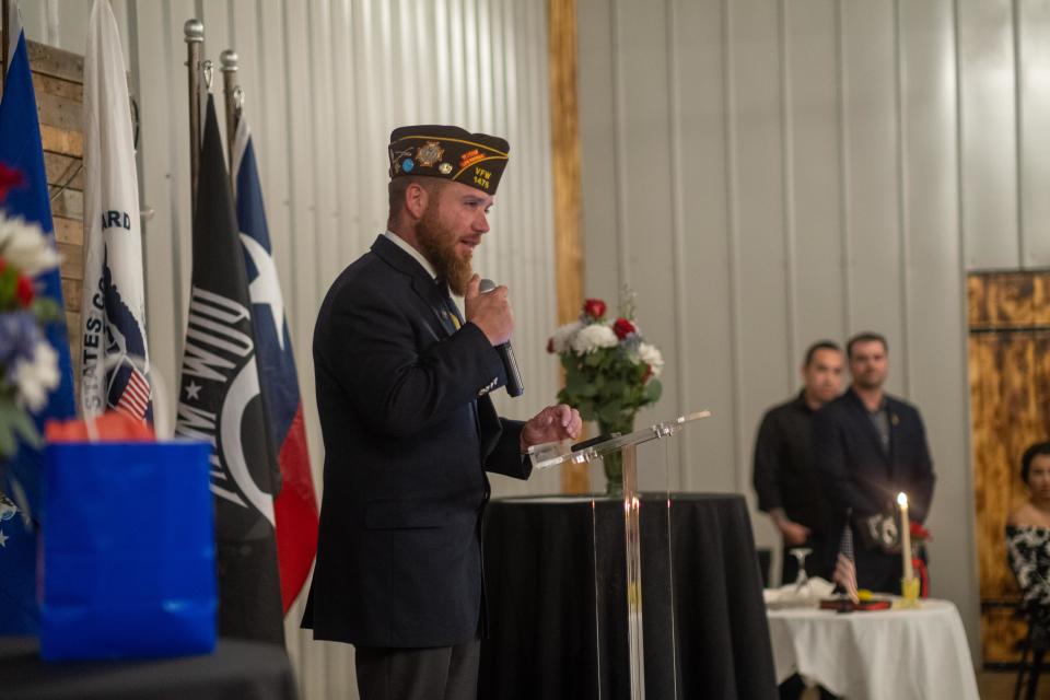 VFW 1475 Commander Mikel McGuire talks Saturday about the significance of the Missing Man Table during the Armed Forces Day Banquet.