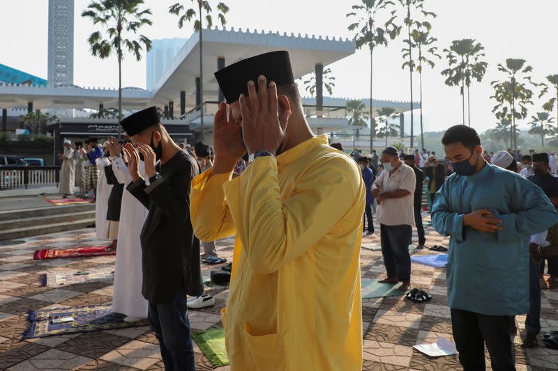 Muslims pray outside the closed National Mosque while celebrating Eid al-Fitr, the Muslim festival marking the end the holy fasting month of Ramadan, amid the coronavirus disease (COVID-19) outbreak in Kuala Lumpur