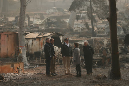 U.S. President Donald Trump visits the charred wreckage of Skyway Villa Mobile Home and RV Park with Governor-elect Gavin Newsom (L), FEMA head Brock Long (2nd L), Paradise Mayor Jody Jones (2n R) and Governor Jerry Brown in Paradise, California, U.S., November 17, 2018. REUTERS/Leah Millis