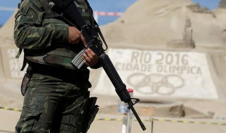 A Brazilian Army Forces soldier patrols on Copacabana beach ahead of the 2016 Rio Olympic games in Rio de Janeiro, Brazil. REUTERS/Ricardo Moraes