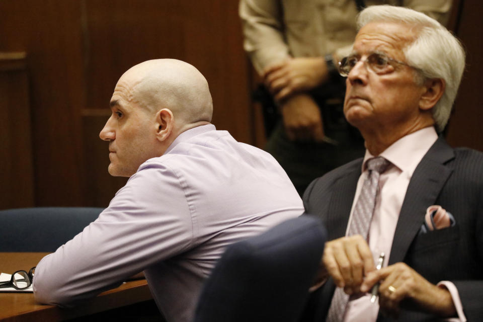 Michael Gargiulo, left, and his attorney Daniel Nardoni look at the jury and listen as guilty verdicts on all counts are read in Los Angeles Superior Court Thursday, Aug. 15, 2019. A jury found Gargiulo guilty of fatally stabbing two women and attempting to kill a third in their Southern California homes. Gargiulo, is also awaiting trial for a similar killing in Illinois in 1993. (Al Seib/Los Angeles Times via AP, Pool)