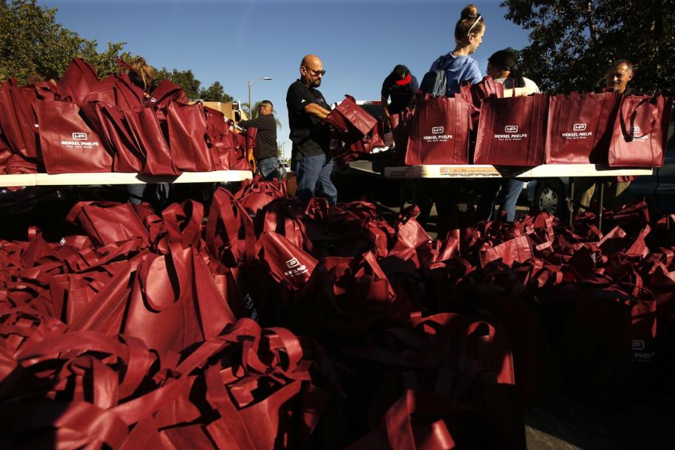 People fill bags outdoors.