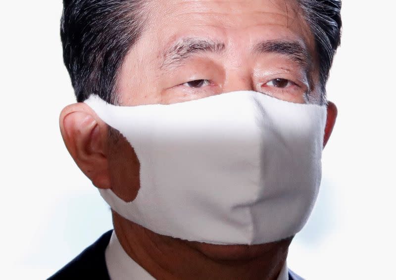 Japan's Prime Minister Shinzo Abe wearing a protective face mask arrives at his official residence, amid the coronavirus disease (COVID-19) outbreak, in Tokyo