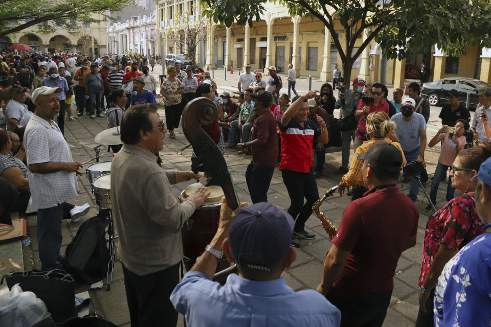 Couples dance to live music at La Libertad Square in San Salvador, El Salvador, Sunday, March 19, 2023. One year ago, President Nayib Bukele suspended constitutional rights and started an all-out offensive on gangs, triggering a radical transformation in some of the country’s most dangerous areas where many Salvadorans enjoy new freedoms like being outside at night, delivery services and open businesses without gangs extorting them for money. (AP Photo/Salvador Melendez)