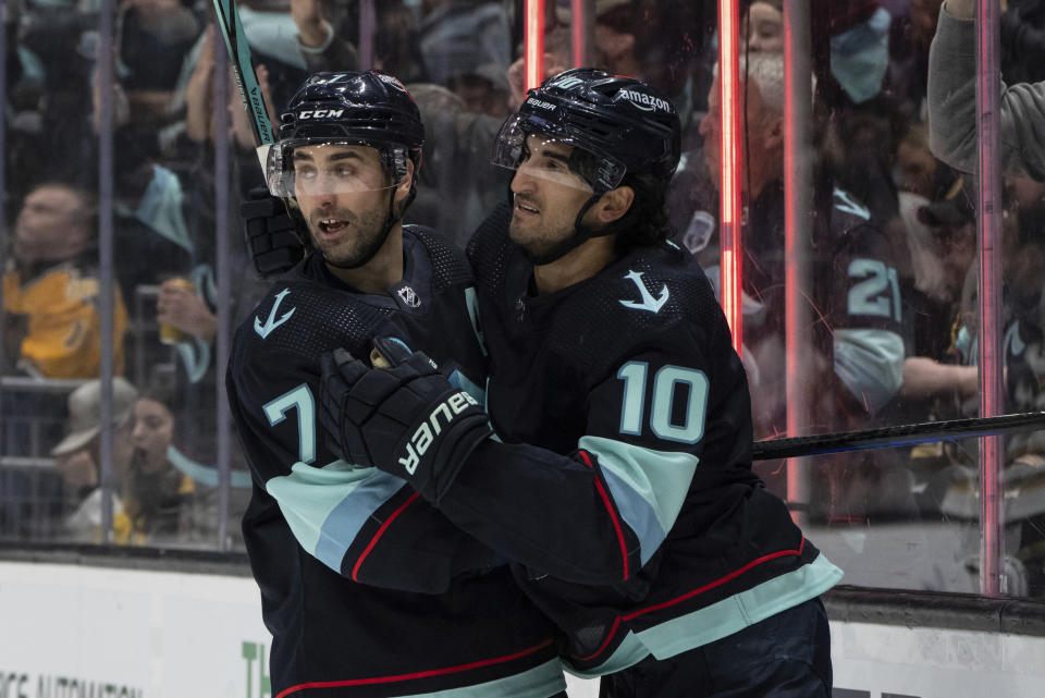 Seattle Kraken forward Jordan Eberle, left, is congratulated by forward Matty Beniers (10) after scoring a power-play goal against the Boston Bruins during the second period of an NHL hockey game, Monday, Feb. 26, 2024, in Seattle. (AP Photo/Stephen Brashear)