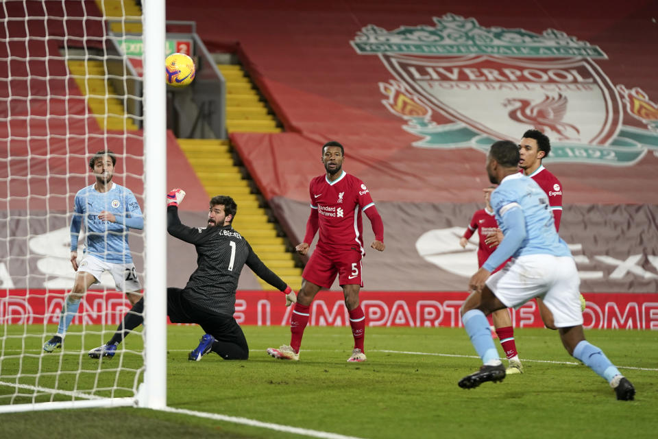 Manchester City's Raheem Sterling 2nd right, scores his side's third goal during the English Premier League soccer match between Liverpool and Manchester City at Anfield Stadium, Liverpool, England, Sunday, Feb. 7, 2021. (AP photo/Jon Super, Pool)