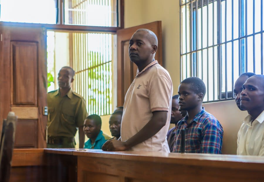 FILE – Pastor Paul Mackenzie, who was arrested on suspicion of telling his followers to fast to death in order to meet Jesus, accompanied by some of his followers, appears at a court in Malindi, Kenya on Monday, April 17, 2023. Kenya’s top prosecutor on Tuesday ordered that 95 people from a doomsday cult be charged with murder, cruelty, child torture and other crimes in the deaths of 429 people believed to be members of the church. (AP Photo, File)