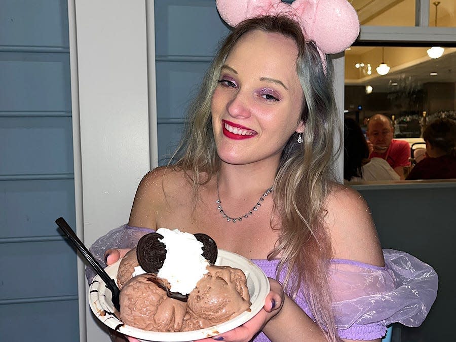 jenna posing with an ice cream sundae at beaches and cream in beach club resort at disney world