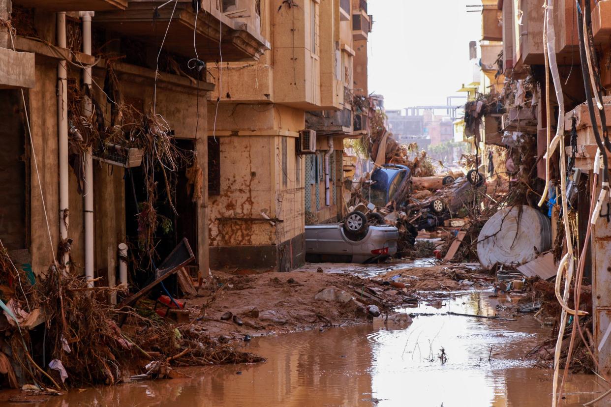 Overturned cars lay among other debris caused by flash floods in Derna, eastern Libya, on Sept. 11, 2023. Flash floods in eastern Libya killed more than 2,300 people in the Mediterranean coastal city of Derna alone, the emergency services of the Tripoli-based government said on Sept. 12.