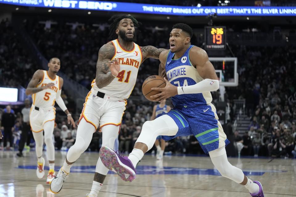 Milwaukee Bucks' Giannis Antetokounmpo drives past Atlanta Hawks' Saddiq Bey during the second half of an NBA basketball game Saturday, Dec. 2, 2023, in Milwaukee. The Bucks won 132-121. (AP Photo/Morry Gash)