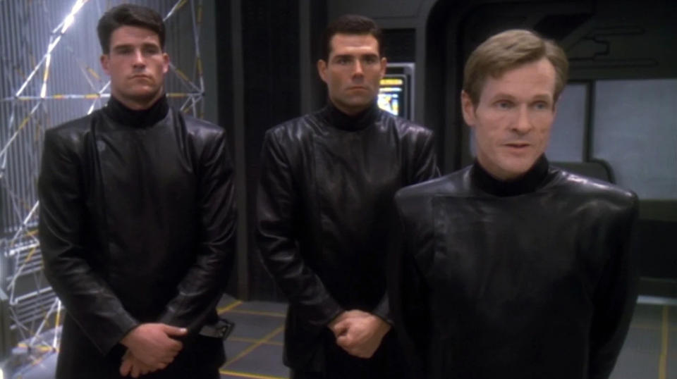 a screenshot from Star Trek Deep Space Nine showing three characters uniformed in all black