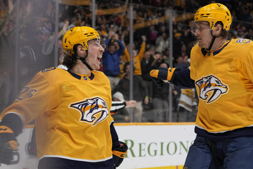 Nashville Predators center Philip Tomasino (26) celebrates a goal with right wing Michael McCarron, right, during the second period of an NHL hockey game against the Washington Capitals, Saturday, Dec. 16, 2023, in Nashville, Tenn. (AP Photo/George Walker IV)