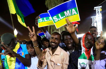 Sudanese demonstrators carry signs referring to the Sudan Liberation Movement/Army and chant slogans as they attend a mass anti-government protest outside the Defence Ministry in Khartoum, Sudan, April 21, 2019. REUTERS/Mohamed Nureldin Abdallah