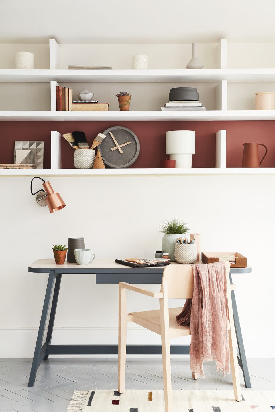 <p>If all your favorite office accessories can't logistically fit on your desk, that doesn't mean you shouldn't put them on display. Install open shelving above your desk and you'll have a ton more space to show off your decor.</p>