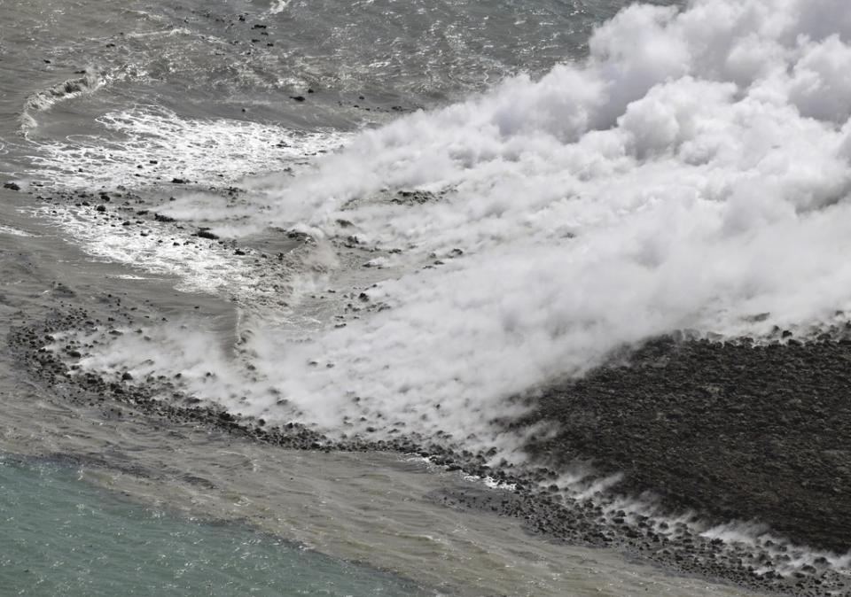 In this aerial photo, plume billows from the water off the Ioto island, following an eruption in Ogasawara, southern Tokyo, Japan, on Oct. 30, 2023. An unnamed undersea volcano, located about 1 kilometer (half a mile) off the southern coast of Iwo Jima, which Japan calls Ioto, started its latest series of eruptions on Oct. 21. (Kyodo News via AP)