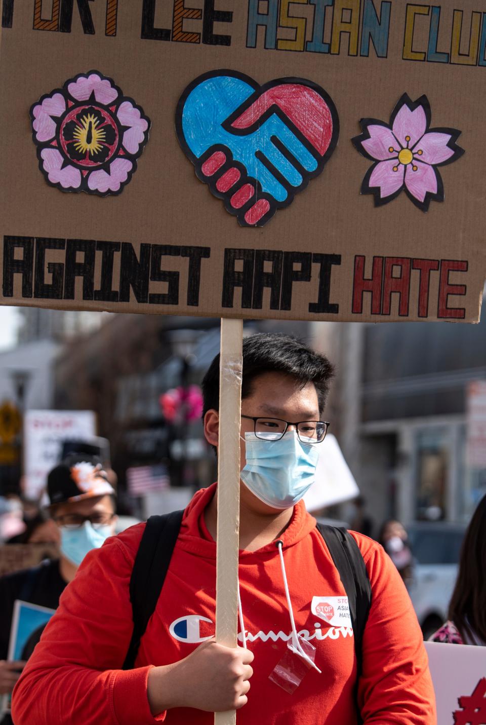 Alex Lee, 16, marches against Asian hate, in a rally organized by the Youth Council of Fort Lee on Saturday March 27, 2021.