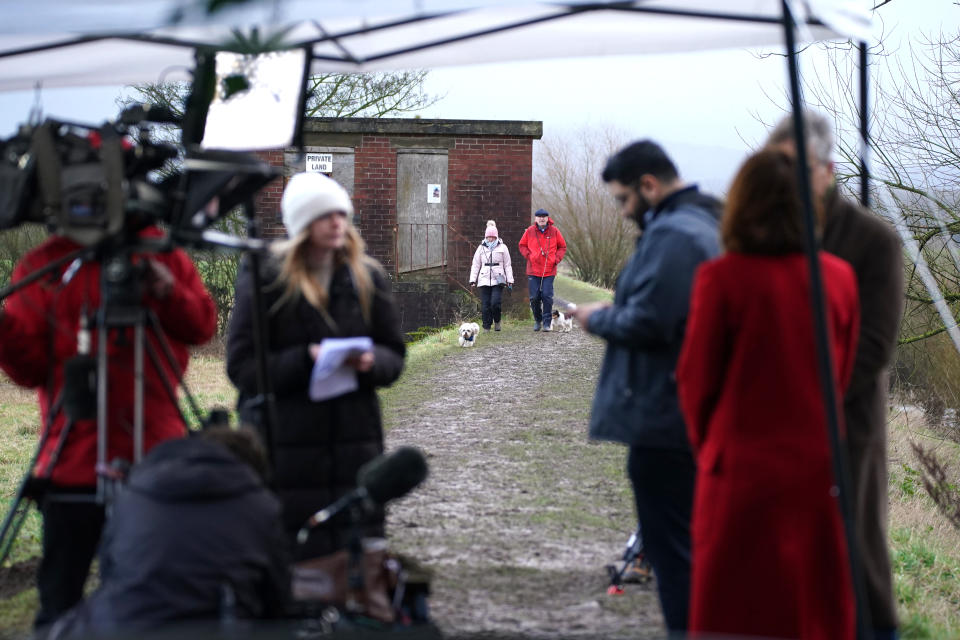 People walking dogs as Sky News presenter Kay Burley (right) reports on Nicola Bulley’s disappearance from St Michael’s on Wyre. Image: Peter Byrne/PA Images via Getty Images.