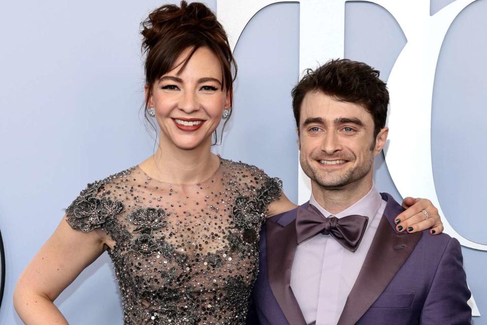 <p>Dimitrios Kambouris/Getty</p> Erin Darke and Daniel Radcliffe attend the The 77th Annual Tony Awards in New York City.