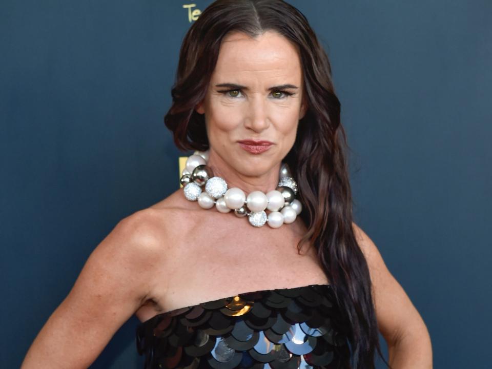 Juliette Lewis poses for photos on the red carpet in a black strapless gown.