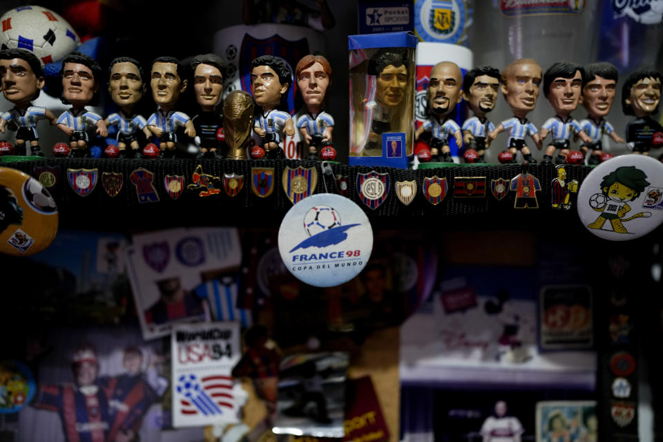 Soccer memorabilia belonging to Osvaldo Santander are displayed on shelves in a room at his home, in Buenos Aires, Argentina, Thursday, Aug. 18, 2022. Santander and his son Julian will travel to Qatar for the World Cup, their third World Cup as fans. (AP Photo/Natacha Pisarenko)