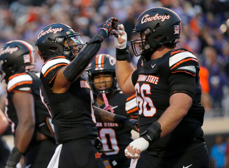 Oklahoma State's Ollie Gordon II (0) celebrates his touchdown with Joe Michalski (66) in the first half of a game against Kansas State on Oct. 6 at Boone Pickens Stadium in Stillwater.