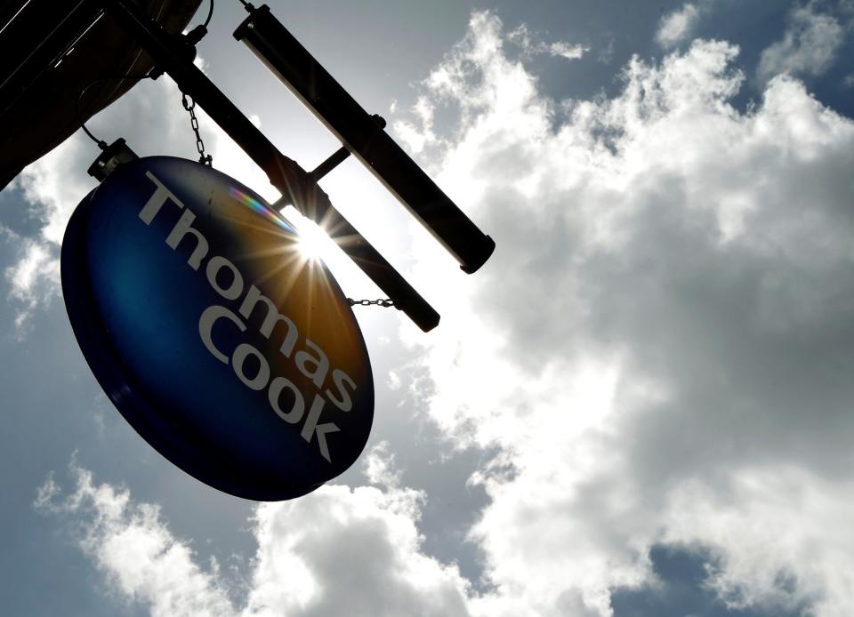 A sign hangs in front of a branch of travel agent Thomas Cook in London (REUTERS)