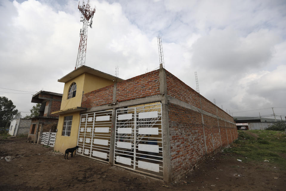 A dog stands outside the drug rehabilitation center that was attacked in Irapuato, Mexico, Thursday, July 2, 2020. Gunmen burst into the center and opened fire Wednesday, killing 24 people and wounding seven, authorities said. (AP Photo/Eduardo Verdugo)