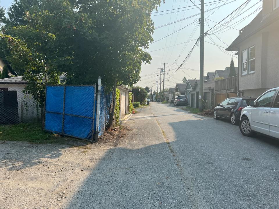 Vancouver police say a store clerk was 'strong-armed' by a would-be robber as she closed up shop. Witnesses say she ended up in this alley, where the suspect fled after dropping his knife in some bushes.