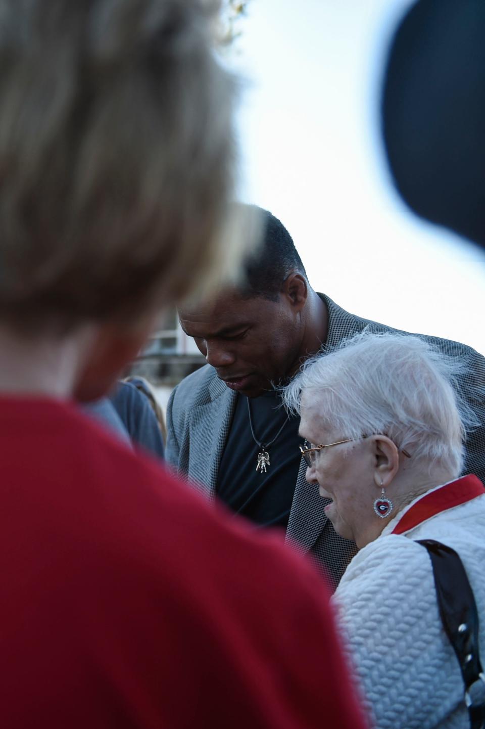 U.S. Senate candidate Herschel Walker speaks with Mary Boles, of West Augusta, during a campaign event at the Columbia County GOP Headquarters in Martinez on Friday, Nov. 12, 2021.