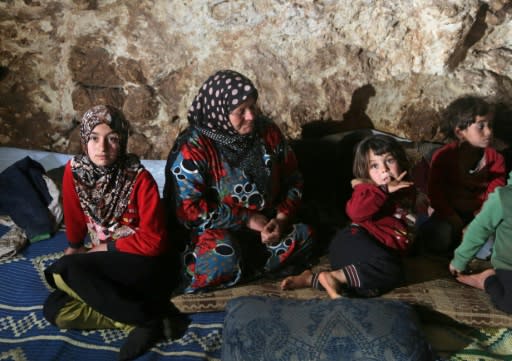 Civilians fleeing the Syrian government's offensive on the country's last rebel bastion have been forced to find shelter where they can -- in caves, abandoned buildings and even a cemetery