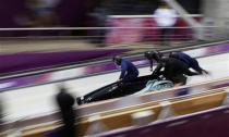 Japan's pilot Hiroshi Suziki (L) and his teammates start during a four-man bobsleigh training event at the Sanki Sliding Center in Rosa Khutor, during the Sochi 2014 Winter Olympics February 20, 2014. REUTERS/Murad Sezer