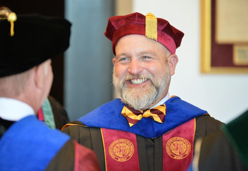 Gannon University President Walter Iwanenko speaks with his predecessor, president emeritus Keith Taylor, left, just prior to Iwanenko's inauguration ceremony at the Warner Theatre in Erie on Sept. 22, 2023.