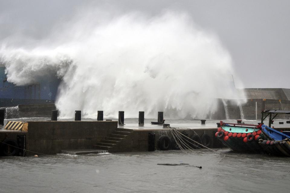 A big wave smashes into a breakwater as Typhoon Usagi approaches the eastern coastal town of Taitung September 21, 2013. Usagi, which has been labelled a super typhoon, made landfall on Itbayat, the Philippine island closest to Taiwan, toppling communication and power lines, uprooting trees, causing landslides and flooding rice and garlic farms. REUTERS/Stringer (TAIWAN - Tags: ENVIRONMENT DISASTER)