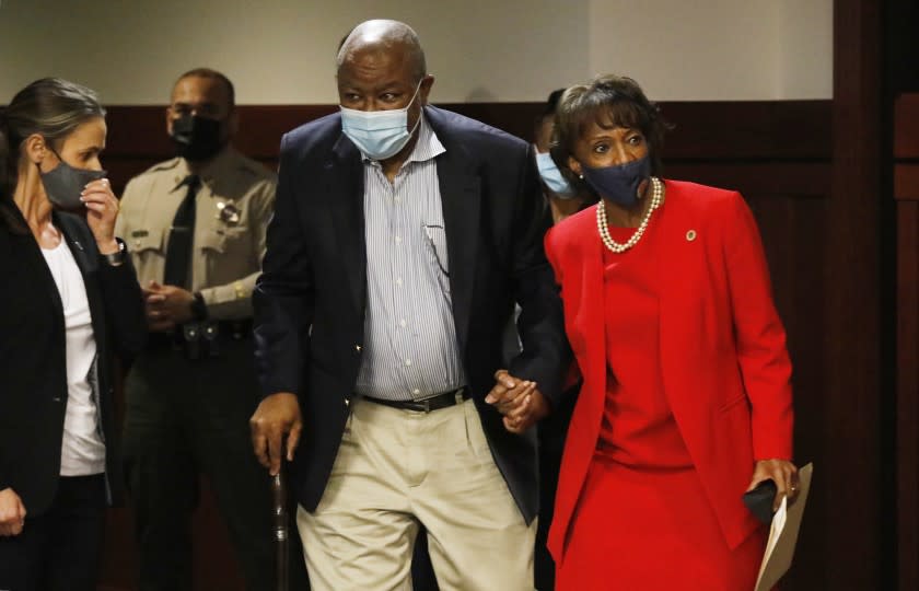 LOS ANGELES, CA - NOVEMBER 06: Los Angeles County District Attorney Jackie Lacey holds hands with her husband David Lacey as she enters the room to address media and a small crowd of supporters regarding her concession to opponent George Gascon at the Hall of Justice in downtown Los Angeles Friday morning. Hall Of Justice on Friday, Nov. 6, 2020 in Los Angeles, CA. (Al Seib / Los Angeles Times