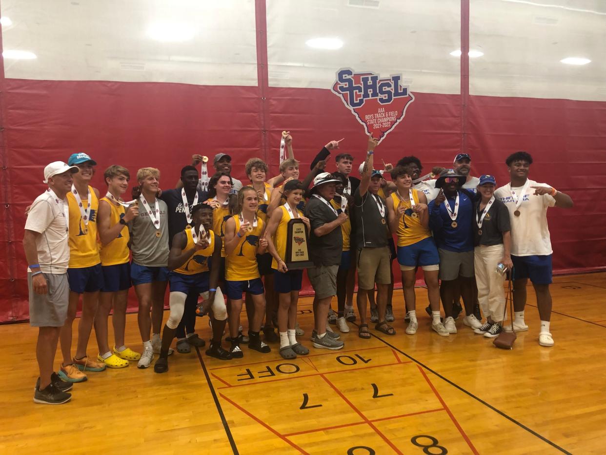 Wren boys track and field team poses with the SCHSL AAA state championship trophy.