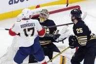 Florida Panthers' Evan Rodrigues (17) sets up to score on the rebound against Boston Bruins' Jeremy Swayman (1) as Brandon Carlo (25) defends during the first period in Game 3 of an NHL hockey Stanley Cup second-round playoff series Friday, May 10, 2024, in Boston. (AP Photo/Michael Dwyer)