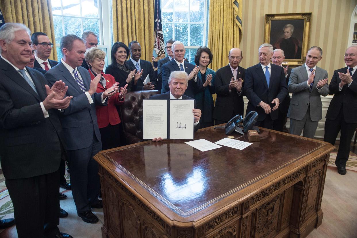 Members of President Donald Trump's Cabinet and other key administration officials surround him in March 2017. Some of them have since departed their jobs under a cloud.